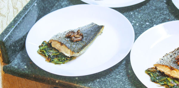 High angle view of fish in plate on marble