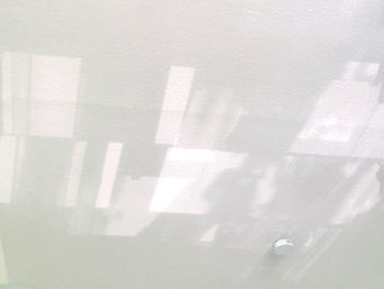 High angle view of shadow on white wall