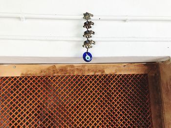 Low angle view of chain hanging on wall