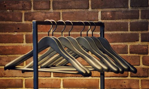 Close-up of clothes hanging on brick wall