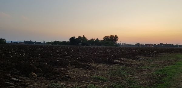 Scenic view of field against sky during sunset