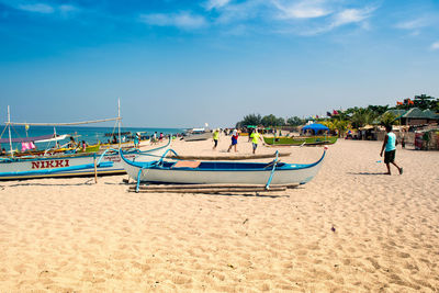 People on beach against sky