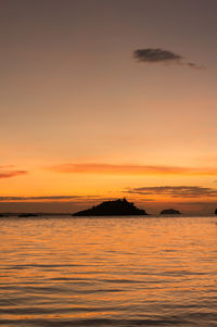 Scenic view of sea against romantic sky at sunset