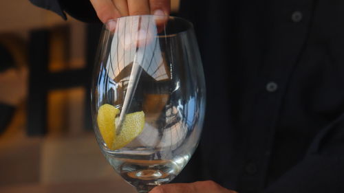 Midsection of woman holding wineglass