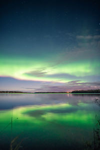 Scenic view of river against sky at night