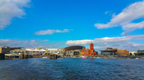 Scenic view of lake and buildings against sky