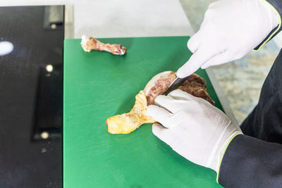 High angle view of person cutting meat