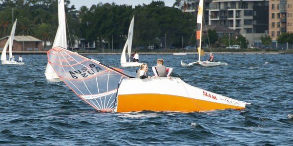 People sailing on sailboat in sea