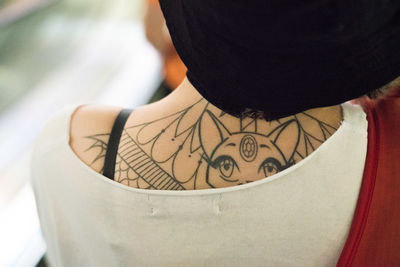 Rear view of woman with tattoo on her back