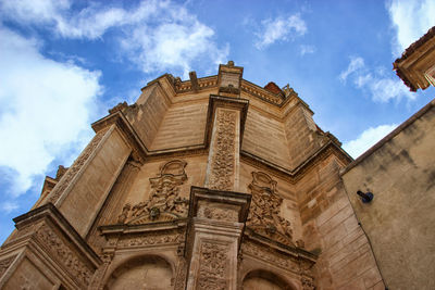 Low angle view of historical building against cloudy sky