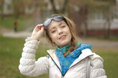 Close-up of smiling young woman holding umbrella