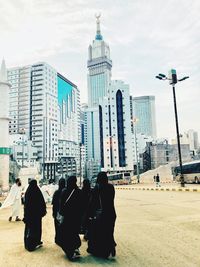 Rear view of women wearing traditional clothing walking on road