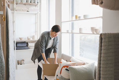 Young woman looking away while standing in box