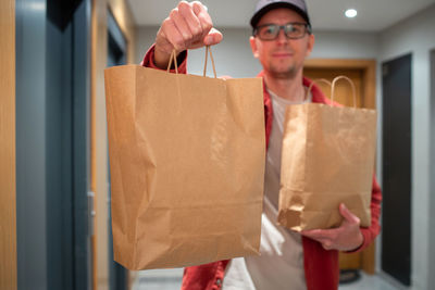 Portrait of young woman holding shopping bags