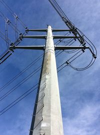 Low angle view of cables against blue sky