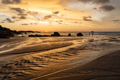Scenic view of beach against sky during sunset