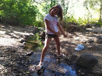 Portrait of cute girl standing on rock