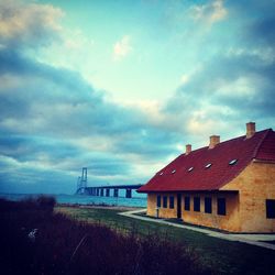 Houses against cloudy sky