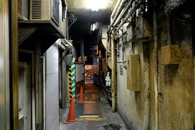 Traffic cones and barricade on walkway of old building