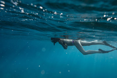 Female snorkelers on the surface of the ocean in hawaii