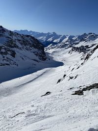 Scenic view of snow covered mountains against clear sky