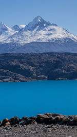 Scenic view of snowcapped mountains against blue sky