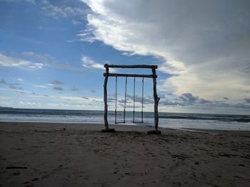 Lifeguard hut on beach against sky