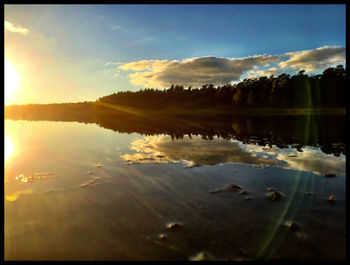 Scenic view of lake at sunset