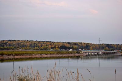 Scenic view of calm lake against cloudy sky