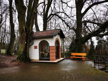 House by trees in park