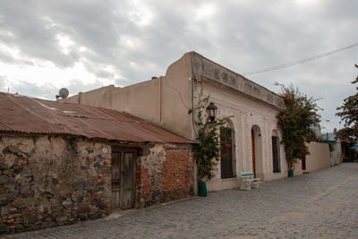 Houses by street against sky