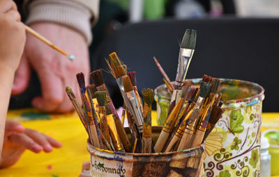 Close-up of paint brushes on table