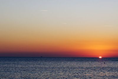 Scenic view of sea against orange sky