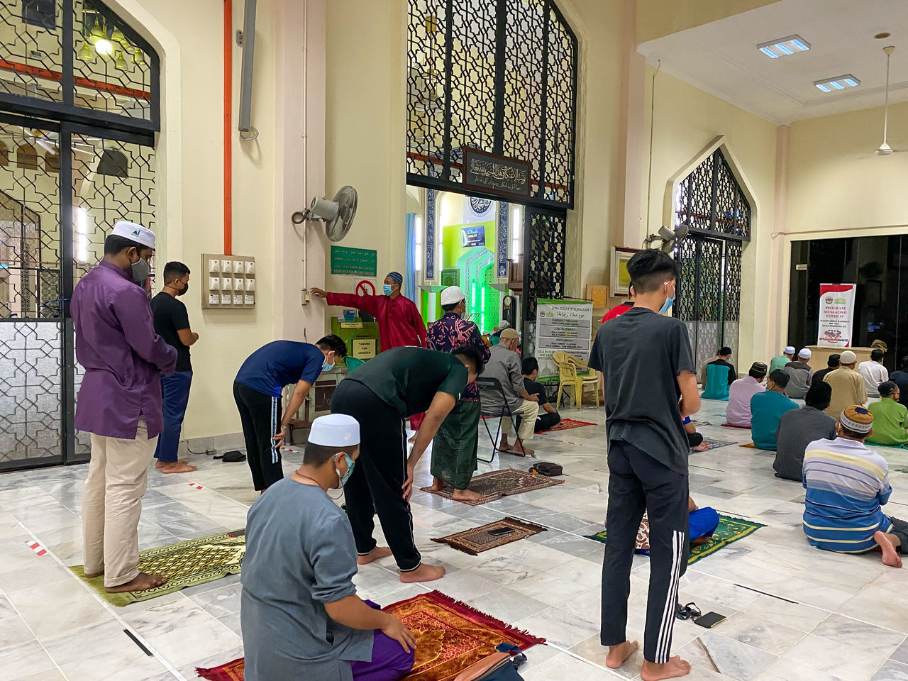 REAR VIEW OF PEOPLE WORKING AT MARKET