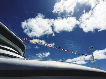 Low angle view of flags against blue sky