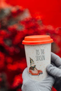 Close-up of hand holding drink against blurred background