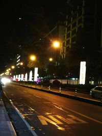 Cars on road in city at night