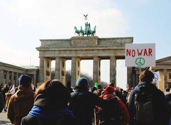Group of people protesting against war in front of brandenburg gate