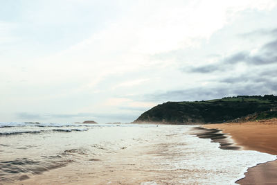 Scenic view of sea against cloudy sky