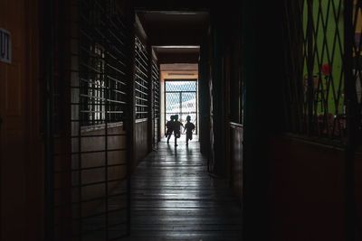 People walking in corridor of building