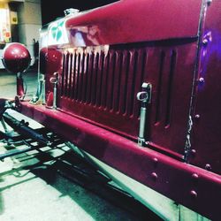 Close-up of red car on road