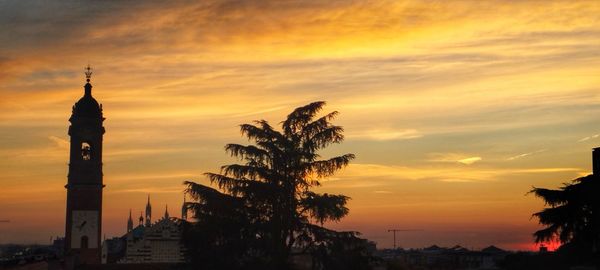 Low angle view of silhouette building against sky during sunset