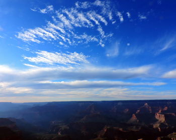 Scenic view of mountains against blue sky