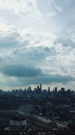 Cityscape against cloudy sky