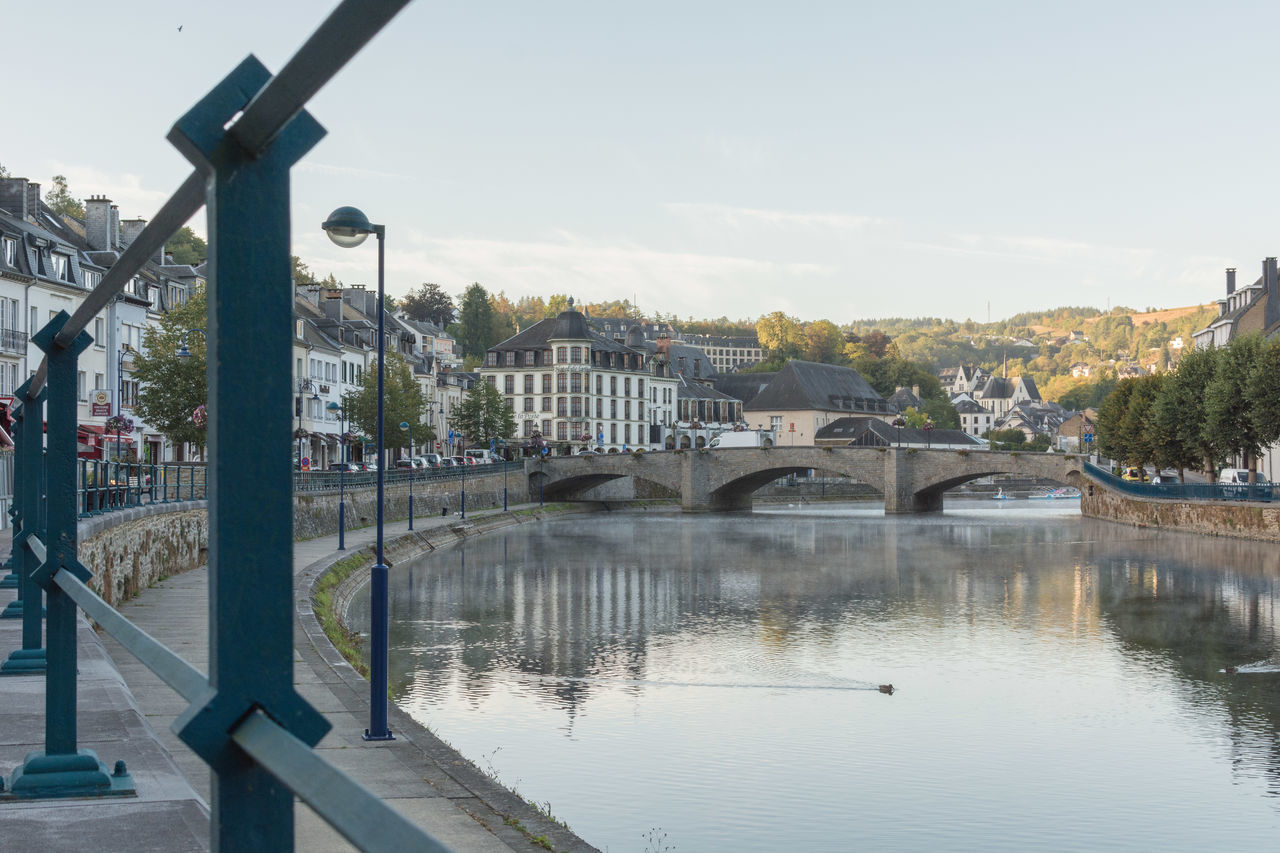 BRIDGE OVER RIVER AGAINST SKY IN CITY