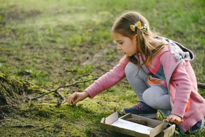 Side view of young woman working at farm