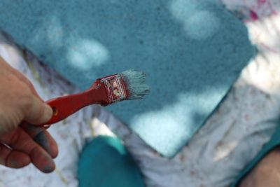 Cropped hand of person holding paintbrush