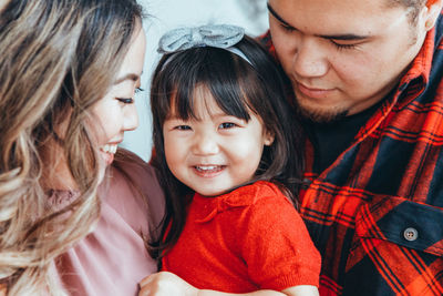 Close-up of mother and father with daughter 