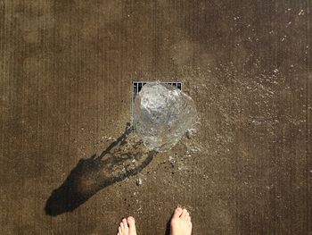 Low section of person standing by fountain