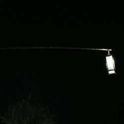 Low angle view of illuminated lights at night